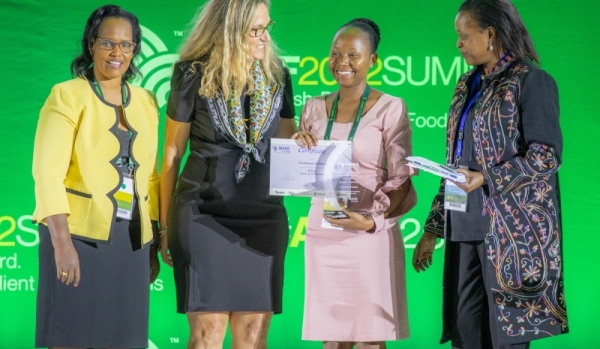 Liliane Uwintwali (second from right) the CEO of Mahwi Tech, receives an award in recognition of her effort to boost the income of smallholder farmers. This was during the just-concluded African Green Revolution Forum (AGRF) held in Kigali.Courtesy