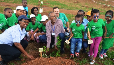 Coletha Ruhamya, the Director General of REMA (left) poses with children during a tree plantating event at Vision City. Sam Ngendahimana.