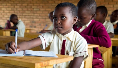 A pupil takes notes during class at Rusheshe Primary School in Kicukiro District. File.