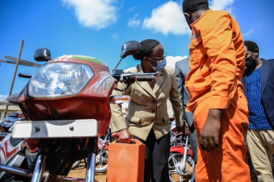 Minister of Environment, Jeanne du2019Arc Mujawamariya, during a campaign to transform fuel use motorbike into e-motorbike. 