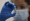 A nurse holds a COVID-19 vaccine on Tuesday, Dec. 8, 2020. Photo: AP