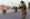 A member of the Afghan Special Forces directs traffic during the rescue mission of a policeman besieged at a check post surrounded by Taliban, in Kandahar province, Afghanistan, July 13, 2021. Photo: Reuters