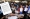 عمالة فلبينية وصورة ضوئية من بيان وزارة العمل في الفلبين حول قرار الكويت بوقف التأشيرات لعمالتها الجديدة