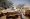 فتاة سودانية لاجئة تجلس على متعلقات عائلتها خارج منزل عائلة تشادية «رويترز»
