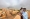 سودانيون يتابعون المعارك في أم درمان (رويترز)