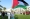 مواطنة ترفع العلم الفلسطيني خلال تجمع تضامني في ساحة الإرادة