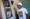 مواطن من غويانا أمام صورة للرئيس علي (أ ف ب)