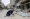 فلسطيني يرمم بقايا مأوى في خان يونس بغزة «أ.ف.ب»
