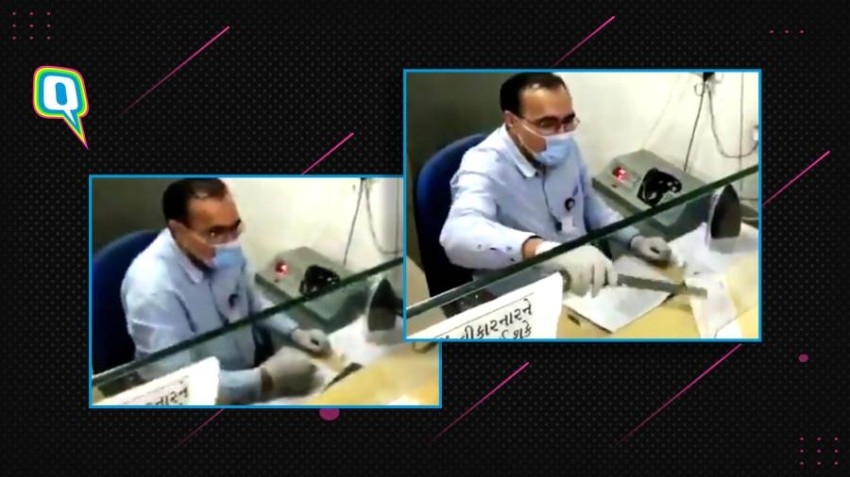 بالفيديو.. مصرفي هندي يعقم الشيكات بـ«مكواة ساخنة»