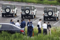 Police officers gather at a Ground Self-Defense Force shooting range in Gifu Prefecture on June 14 following a fatal rifle attack. | Kyodo