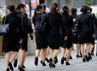A survey showed the employment rate among women hit a record high of 53.2%, partly attributed to government efforts to help mothers work while raising children. | Reuters 