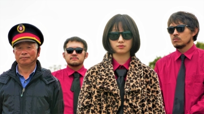 Director Hirobumi Watanabe (second from left) stars alongside his brother Yuji (far right), who has served as composer on all of his films, in his new feature “Techno Brothers,” which follows a sibling trio on the road to Tokyo to find success in the music business. 