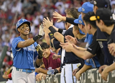 The Pacific League's Chusei Mannami is congratulated by his teammates after his home run during Game 2 of NPB's All-Star series in Hiroshima on Thursday.
