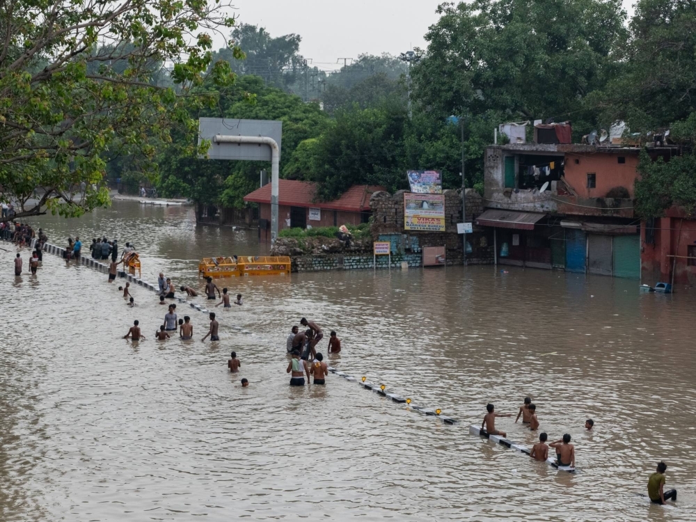 Residents in flood waters in New Delhi on July 14