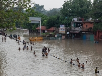 Residents in flood waters in New Delhi on July 14 | Bloomberg