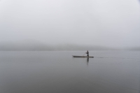 A paddler using a traditional Ainu canoe on Lake Poroto at the Upopoy National Ainu Museum and Park in Shiraoi, Hokkaido, in June.  | Chang W. Lee / The New York Times