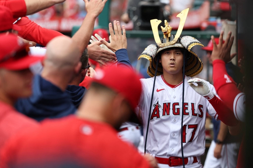 Shohei Ohtani celebrates in the dugout after his 36th home run of the season during a win over the Pirates in Anaheim, California, on Sunday.