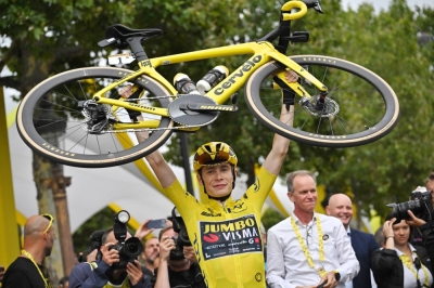 Jonas Vingegaard celebrates with his bike after winning the Tour de France in Paris on Sunday.