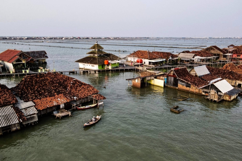 Villagers' houses with the surrounding area submerged by sea water at Timbulsloko village in Demak, Indonesi.