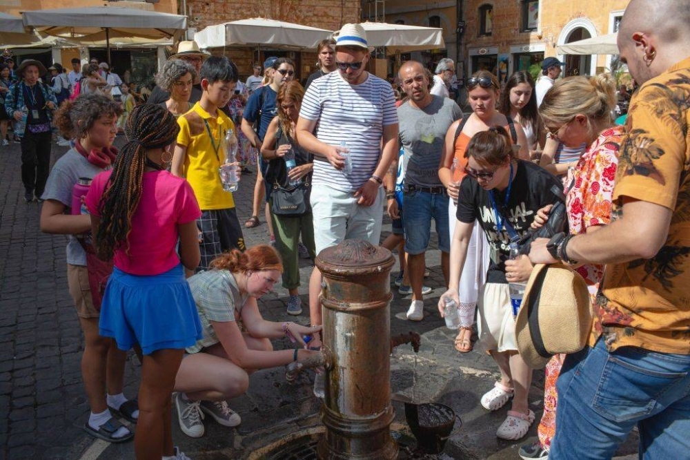 Visitors crowd around a water fountain during a heat wave in Rome, Italy, on July 17.