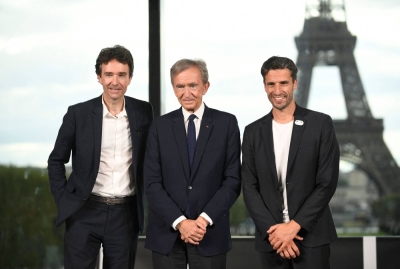 LVMH CEO Antoine Arnault (left), LVMH head Bernard Arnault (center) and Paris 2024 Organising Committee President Tony Estanguer pose at a news conference announcing the luxury titan as a premium sponsor of the Paris Games on Monday.