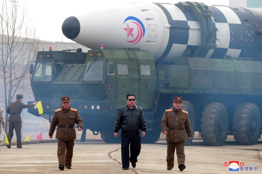 North Korean leader Kim Jong Un walks in front of an intercontinental ballistic missile in this undated photo released in March 2022.