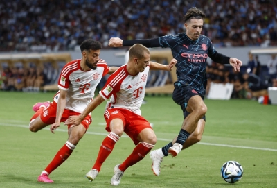 Manchester City's Jack Grealish (right) contends for the ball with Bayern's Joshua Kimmich (center) during an international friendly at Tokyo's National Stadium on Wednesday.