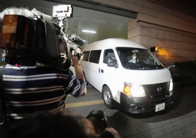 A vehicle carrying Runa Tamura is seen at a police station in Sapporo on Monday.