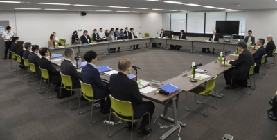 Members of a labor ministry panel on wages meet in Tokyo on Friday.
