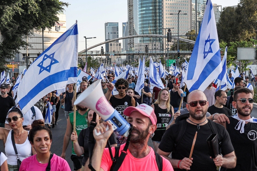 Demonstrators march against the Israeli government's judicial reform plan in Tel Aviv on Monday. 