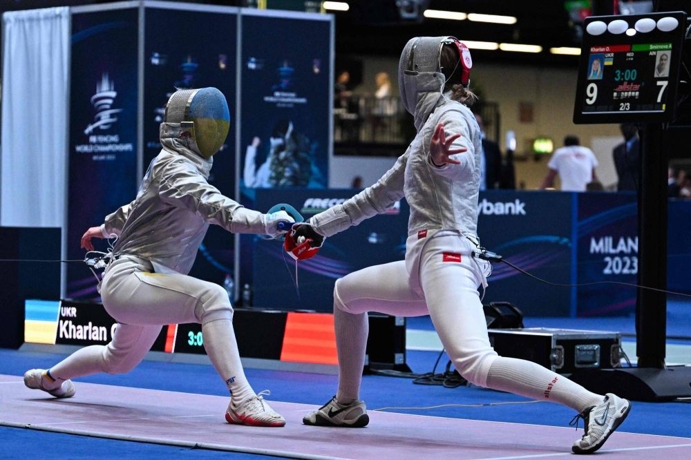 Olga Kharlan (left) and Anna Smirnova compete during the Fencing World Championships in Milan on Thursday.