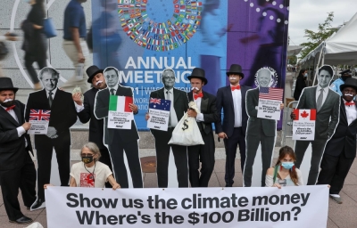 Activists dressed as debt collectors call for finance action during a demonstration outside the IMF-World Bank headquarters in Washington in October 2021.  