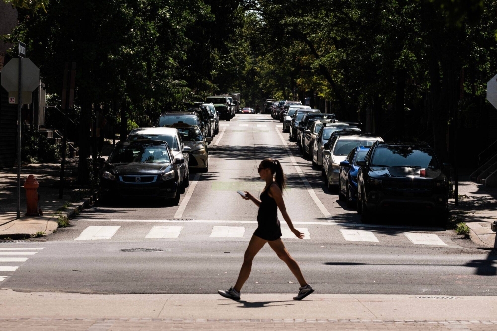 A pedestrian crosses a street during a heat wave in Philadelphia on Friday. Scientists suspect the last several years have been warmer than any point in more than 125,000 years.