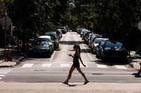 A pedestrian crosses a street during a heat wave in Philadelphia on Friday. Scientists suspect the last several years have been warmer than any point in more than 125,000 years. | Bloomberg 