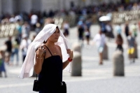A woman in Vatican City on July 19 during a heat wave. Projecting temperatures is inherently imprecise because modern humans have never experienced such extremes. | Reuters