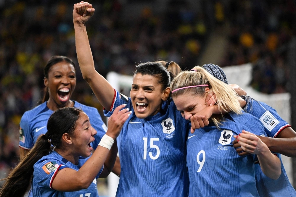 France's Eugenie Le Sommer (second from right) celebrates scoring the team's first goal against Brazil during their 2023 FIFA Women's World Cup group-stage game in Brisbane, Australia, on Saturday.