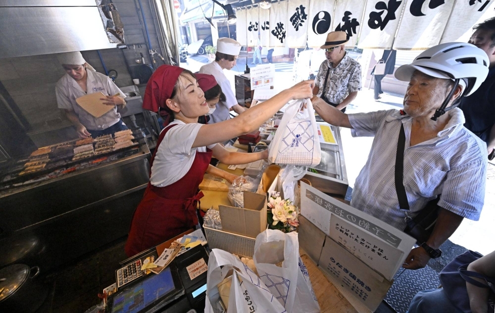 Customers visit a grilled eel store in Meguro Ward, Tokyo, on Saturday.