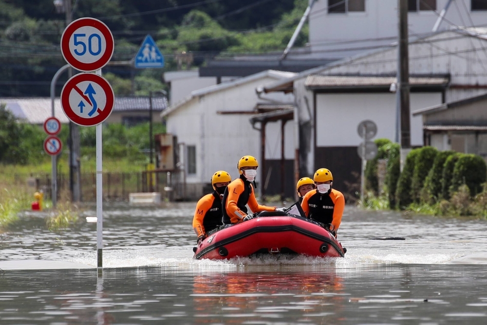 Rescue workers search for flood survivors in Takeo, Saga Prefecture, in August 2021. 