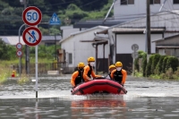 Rescue workers search for flood survivors in Takeo, Saga Prefecture, in August 2021.  | REUTERS