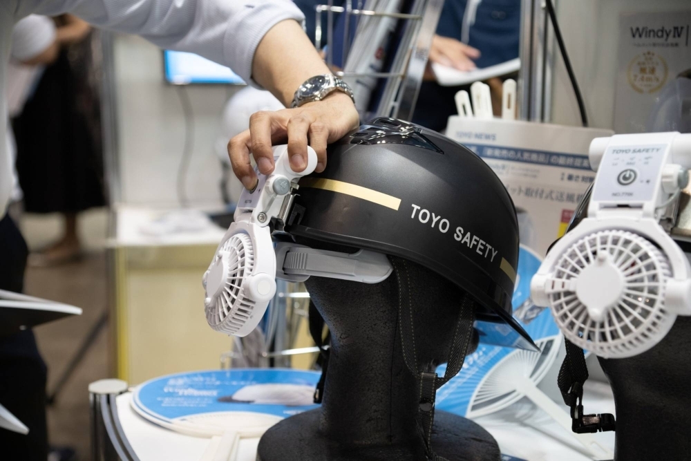 A Toyo Safety Industrial helmet with a built-in fan is showcased at Extreme Heat Countermeasures Exhibition in Tokyo in July.