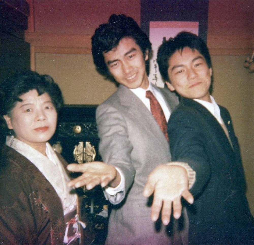 Yasushi Ozaki (center) and his brother, singer-songwriter Yutaka Ozaki, pose next to their mother in this undated image. 