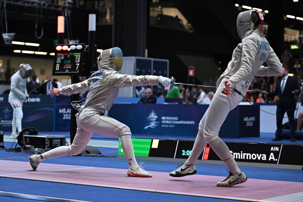 Ukrainian Olga Kharlan (left) and Russian Anna Smirnova compete during the women's sabre senior individual qualifiers at the FIE Fencing World Championships in Milan on Thursday.