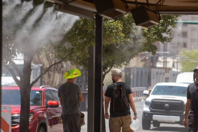 Residents walk through misters during a heat wave in Phoenix, Arizona, on July 20.