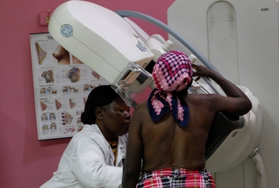 A radiographer prepares a patient to undergo a mammogram to look for early signs of breast cancer in the radiology unit at a hospital in Nairobi.
