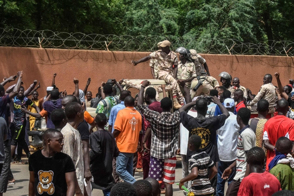 Protesters cheer Nigerien troops as they gather in front of the French Embassy in Niamey during a demonstration that followed a rally in support of Niger's junta in the country's capital on Sunday.