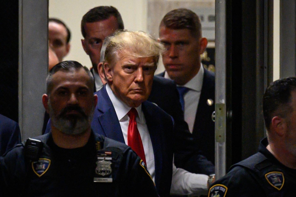 Former U.S. President Donald Trump makes his way inside the Manhattan Criminal Courthouse in New York on April 4. Trump was indicted on Monday over his efforts to overturn the results of the 2020 election — the most serious legal threat yet to the former president as he campaigns to return to the White House.