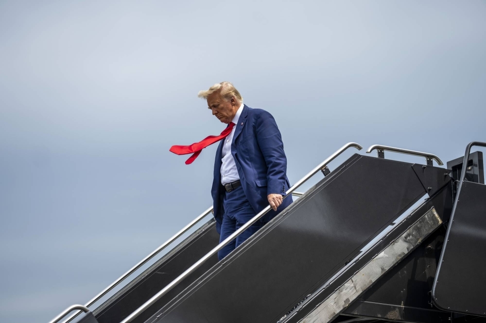 Former U.S. President Donald Trump, a candidate for the Republican presidential nomination, arrives at Reagan National Airport in Washington en route to his arraignment in federal court on Thursday.