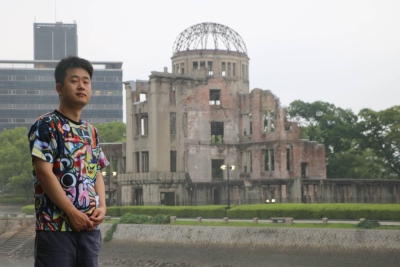 Family legacy successor Kento Ogata, who tells the story of his grandfather Shozo Matsubara, an atomic-bomb survivor, in front of the Atomic Bomb Dome in Hiroshima on July 8