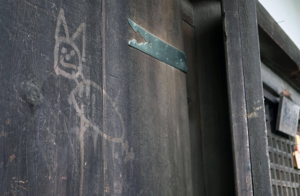 A wooden door of a Todaiji temple building in Nara Prefecture after it was vandalized with an image of what looks like a cat on Thursday.