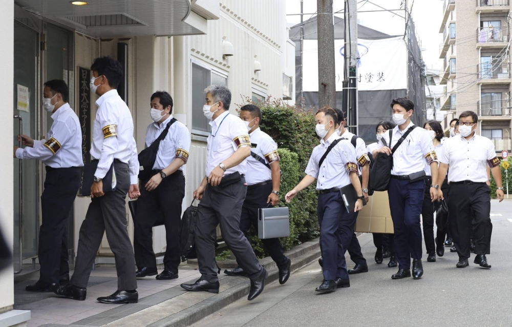 Tokyo Metropolitan Police investigators search the dormitory of Nihon University's American football team in Tokyo on Thursday.